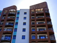 Façade d’un immeuble de logements collectifs avec balcons et bardage en bois